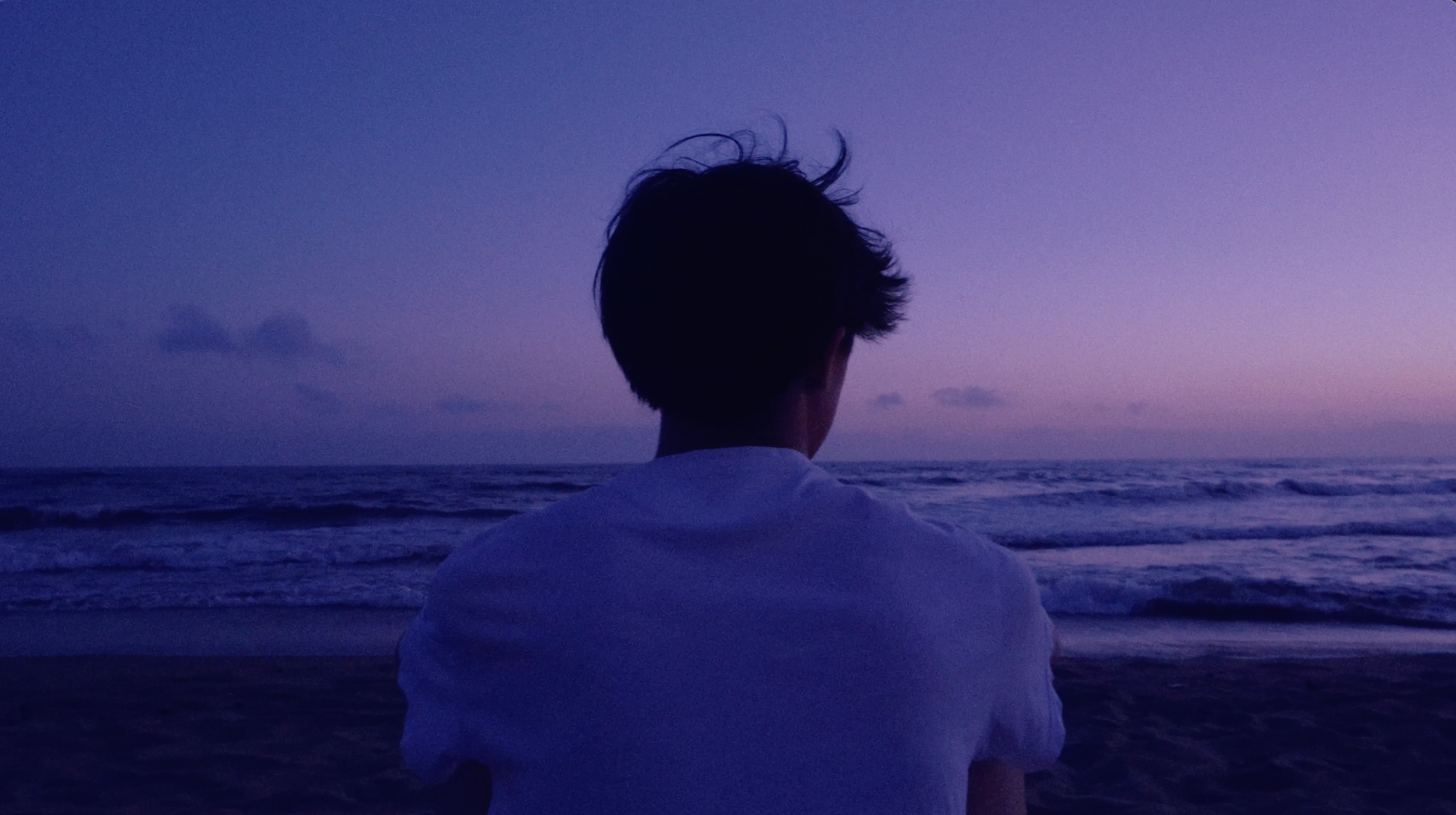 A person facing the sea at sunset in Forte Dei Marmi, Italy