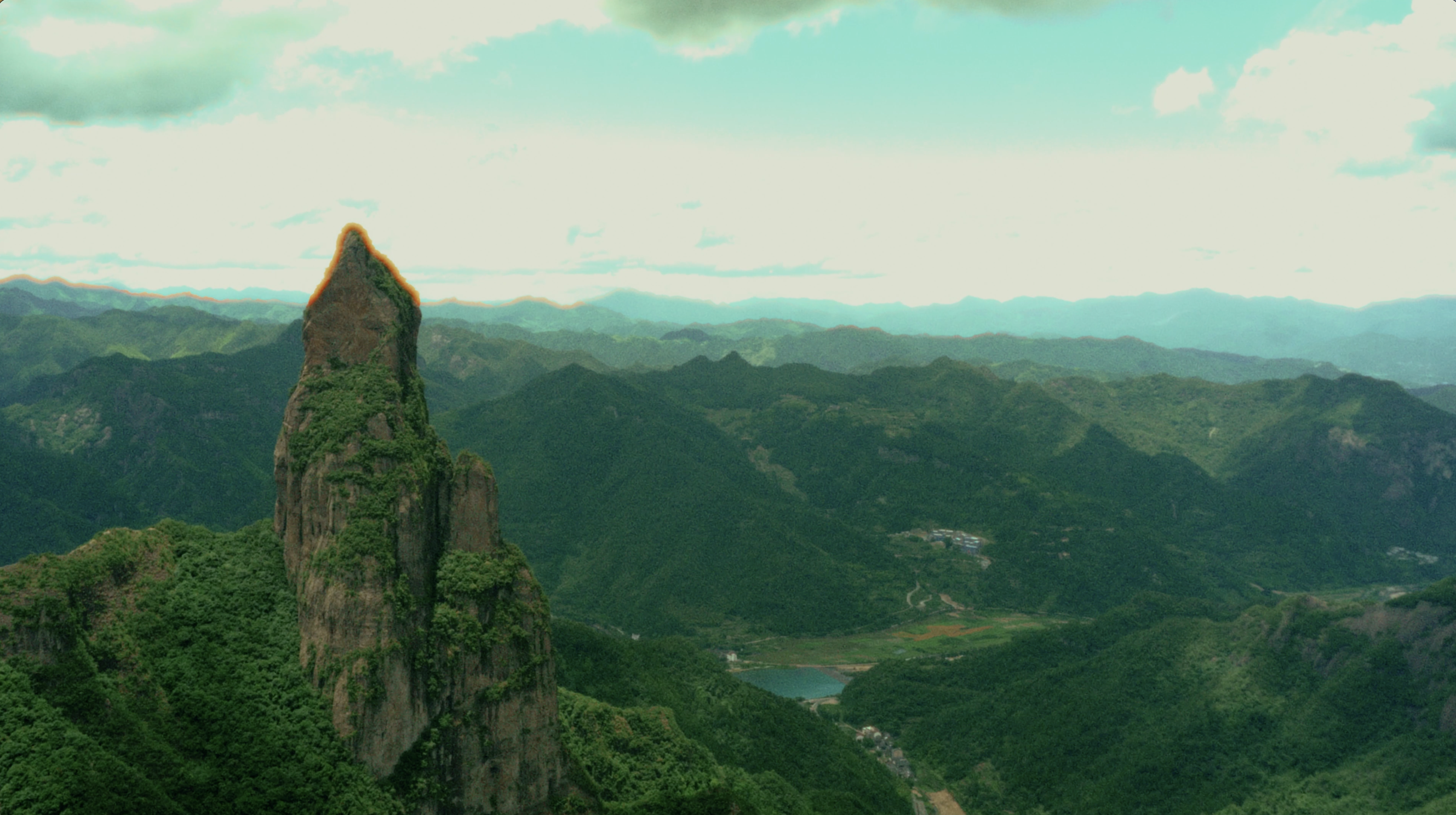 A dramatic mountain peak overlooking the green hills of Wenzhou, China