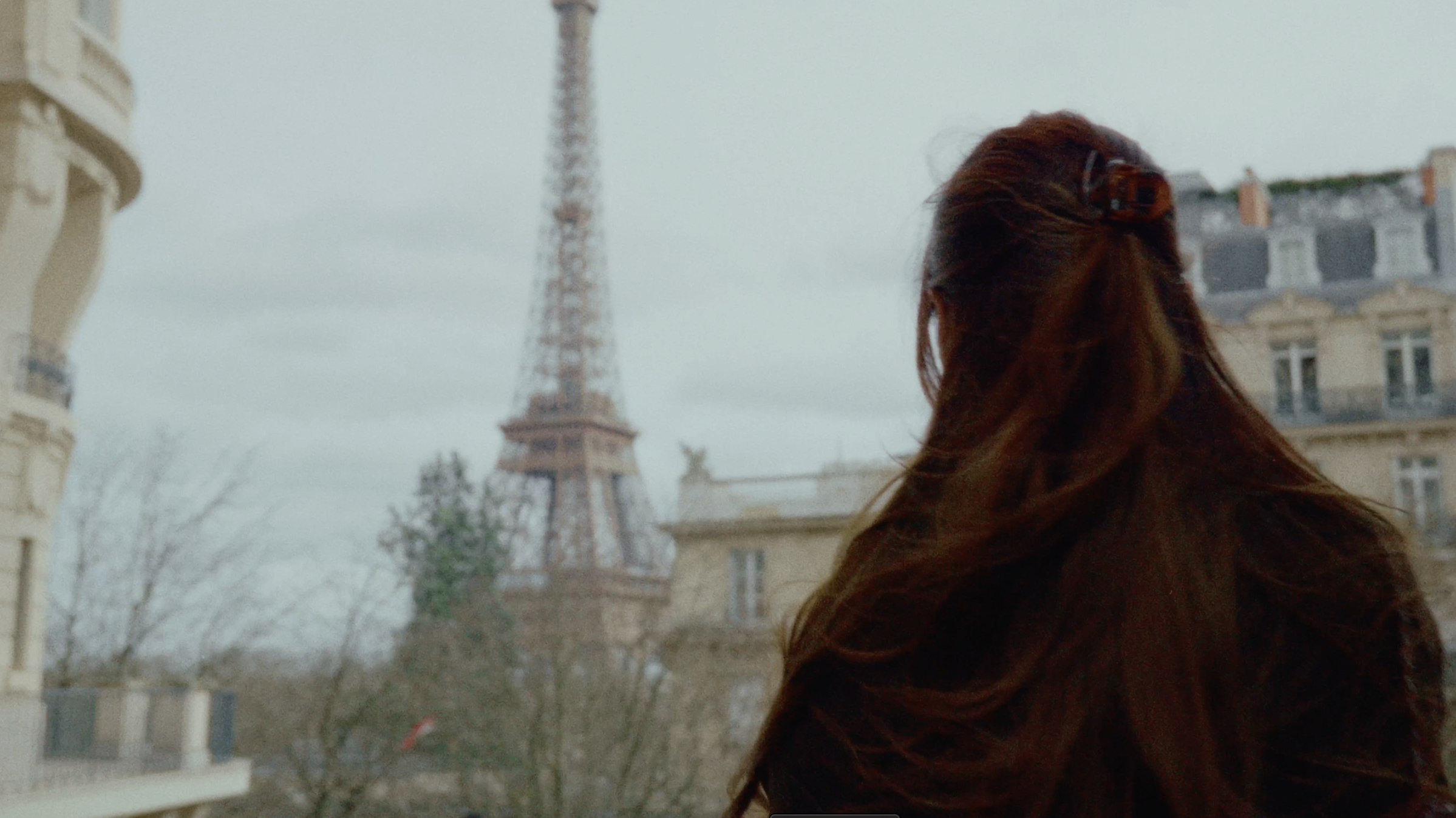A woman in Paris with the Eiffel Tower in the background
