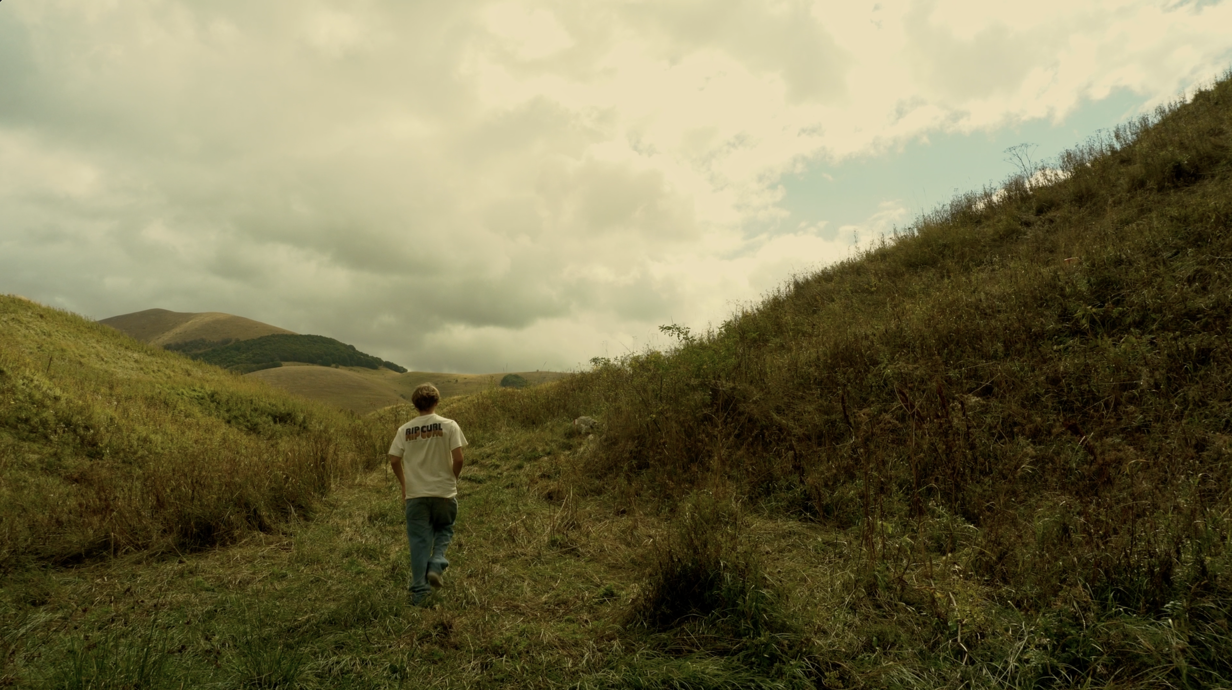 A person walking through the hills near Norcia, Italy